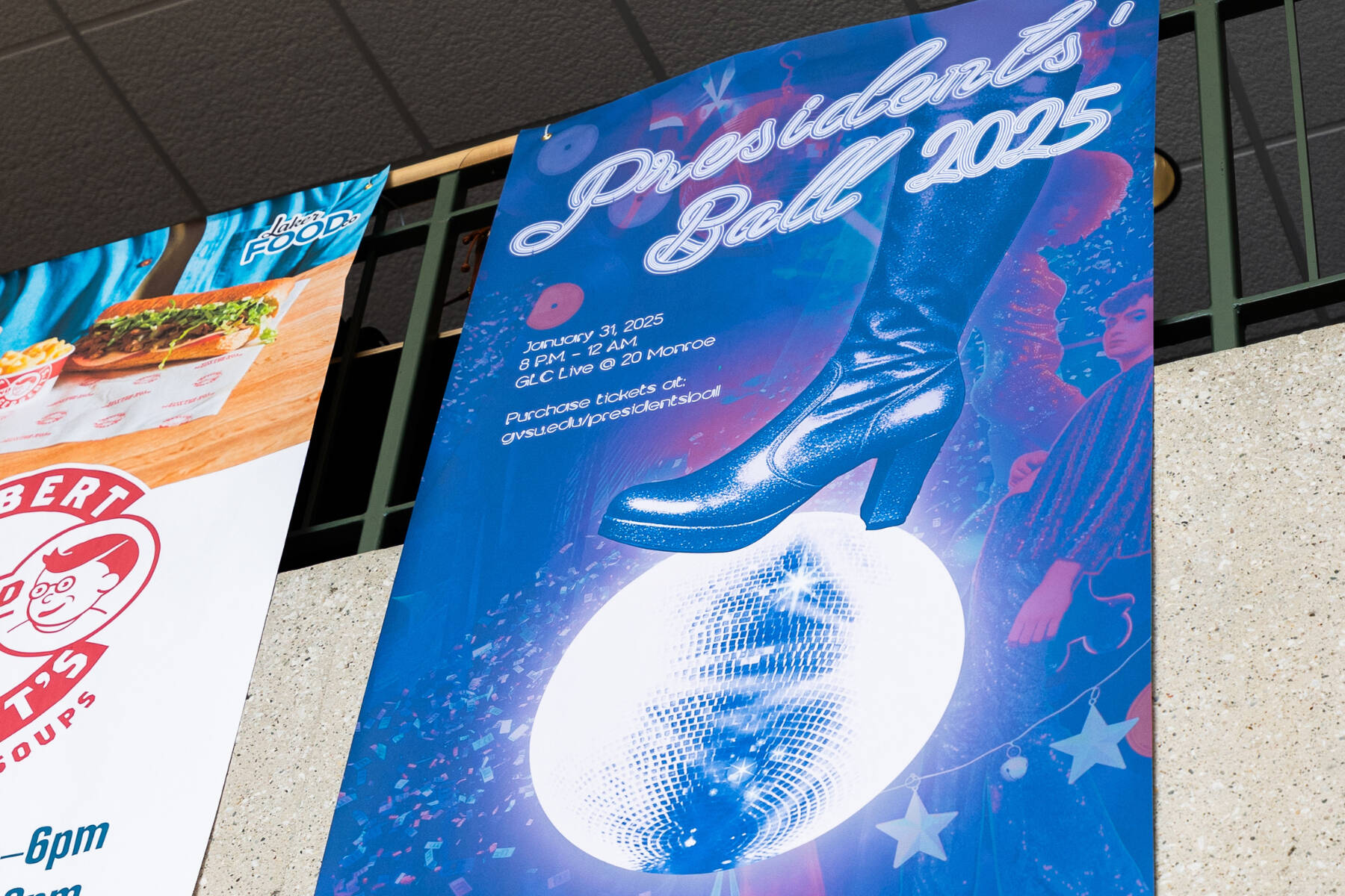 A paper banner hanging in Kirkhof that says "Presidents' Ball 2025"